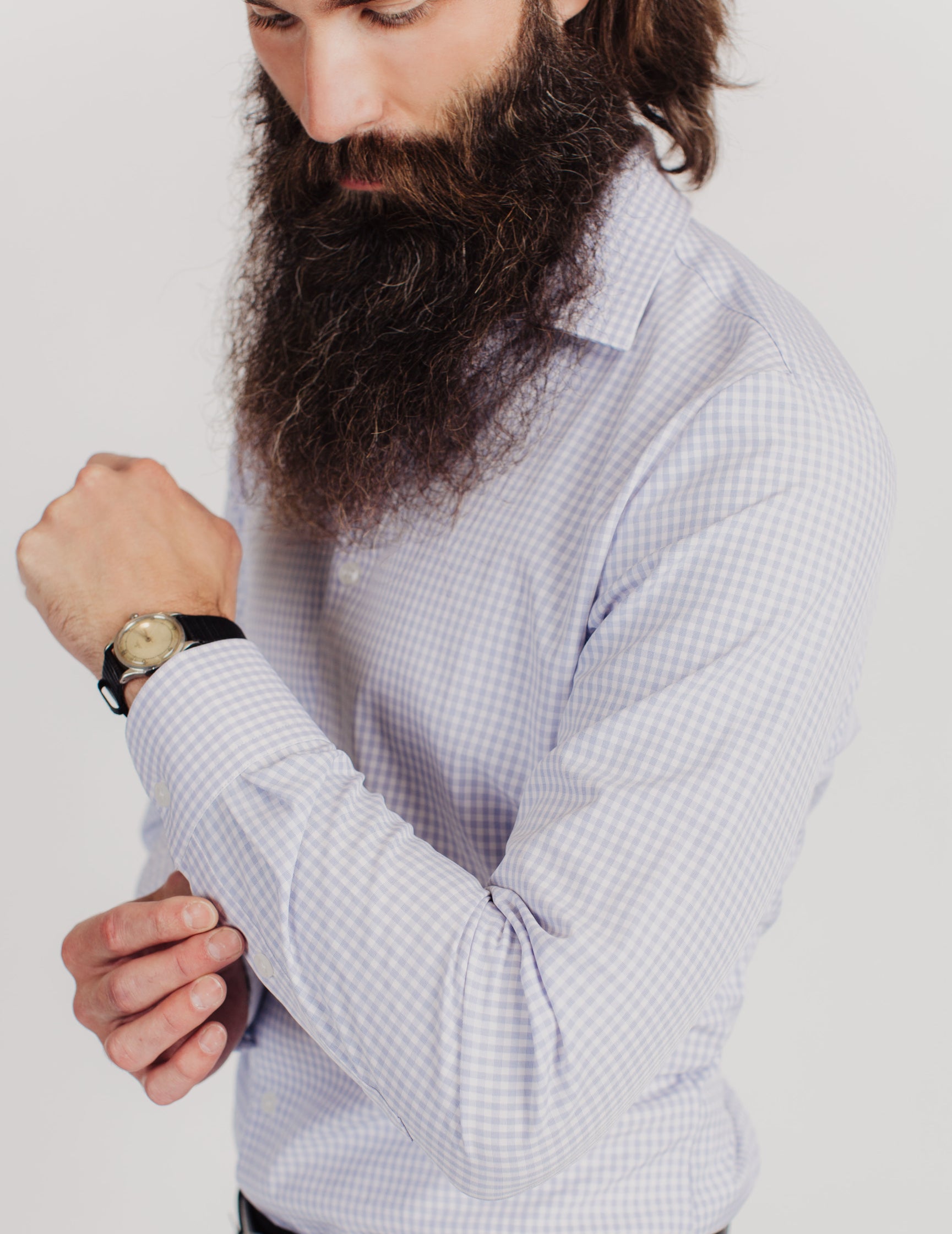 bearded Man wearing Light blue plaid dress shirt 